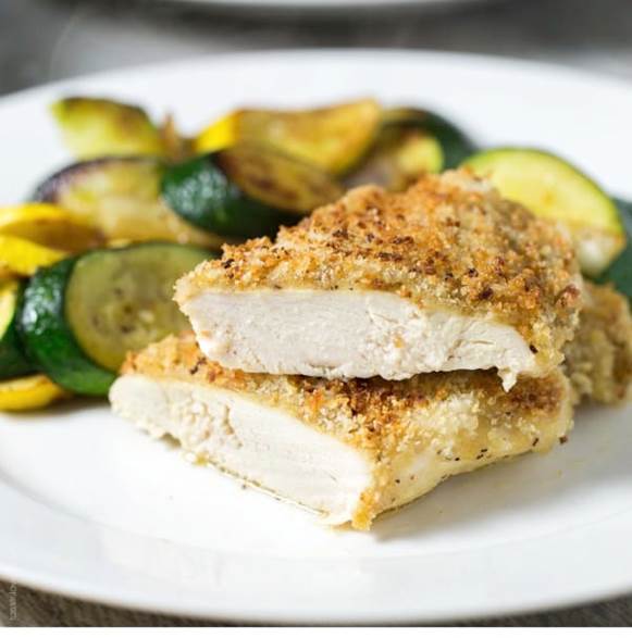 Crispy oven baked honey mustard chicken - chicken breasts smothered in honey mustard sauce, topped with panko bread crumbs, and baked in the oven until golden and crispy. The easiest 30 minute chicken dinner!